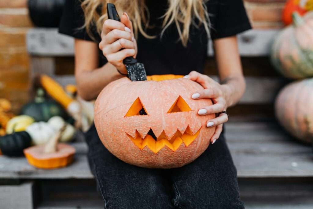 Woman carving a jack-o