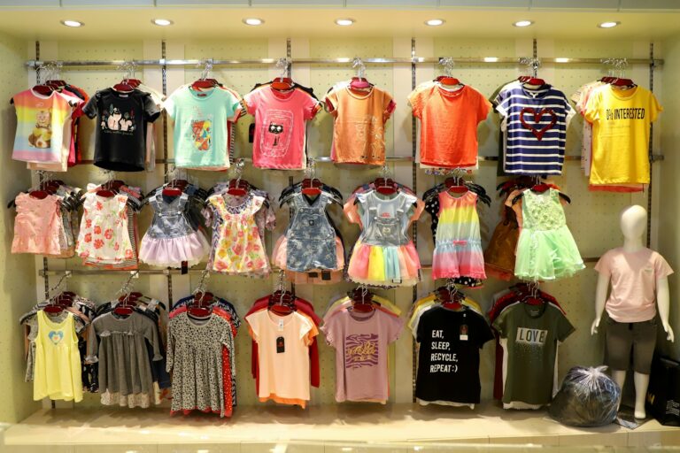 The Latest Trends in Children's T-Shirt Designs: Prints, Colors, and Styles Children's clothing displayed on racks in a store.